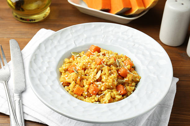 istock Delicious pumpkin risotto served on wooden table, closeup 2227093491