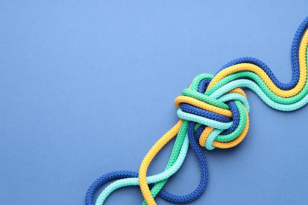 istock Colorful ropes tied in knot on blue background, top view with space for text. Unity concept 2227093914