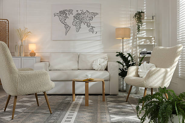 Soft armchairs, coffee table, sofa and houseplants in room