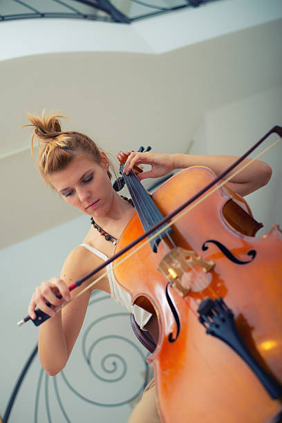 istock Young woman playing cello 2227095082