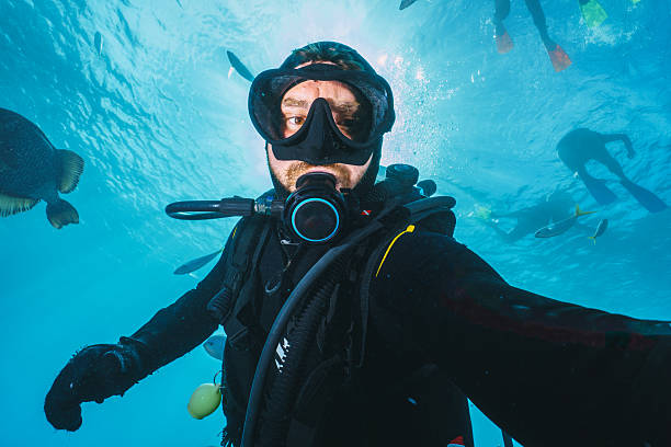 istock Scuba diver taking a selfie underwater with tropical fish 2227095829
