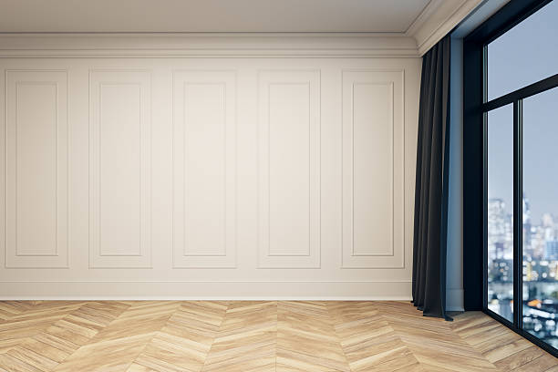 istock Blank white wall with molding in modern interior room with parquet floor and large window overlooking evening city view, perfect for mockup design. 3D Rendering 2227097045
