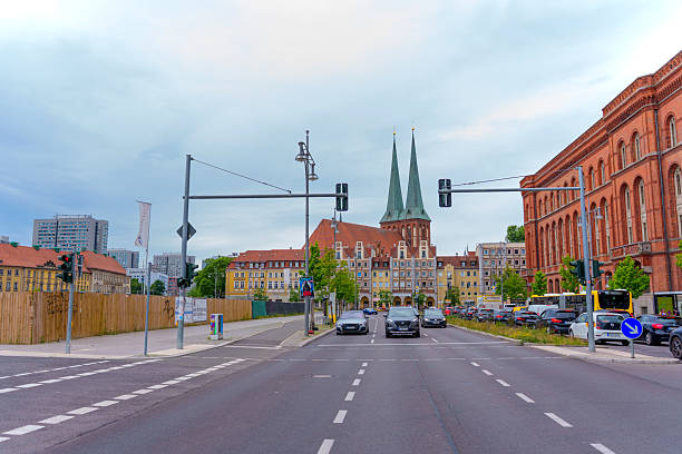 Elevated view of Potsdam's urban scenery, showcasing modern buildings, historical architecture, and green spaces under a sunny sky.