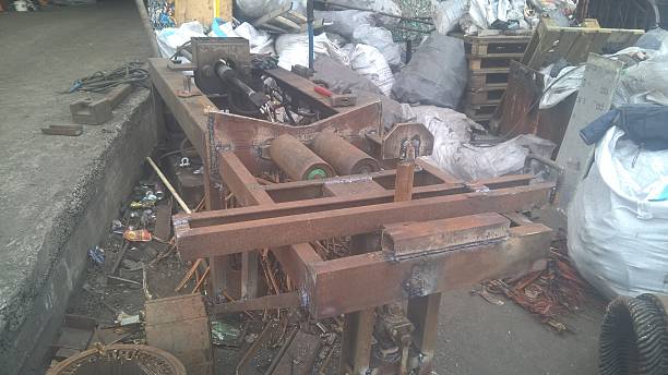istock Rusty industrial equipment surrounded by debris at a scrapyard in the afternoon light 2227098308