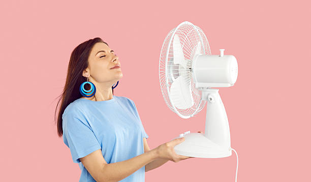 istock Overheated woman breathe fresh air from ventilator 2227099696