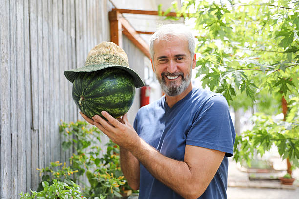 istock Happy Elderly Man Enjoying Summer Fruit Harvest 2227100927