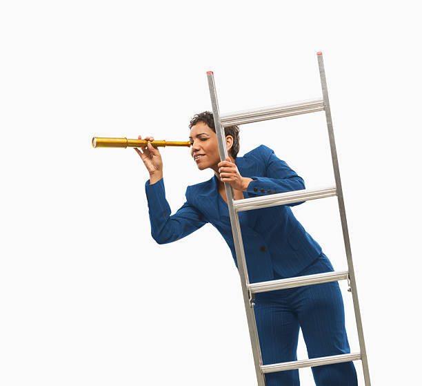 istock Businesswoman on ladder using monocular, 2227105192