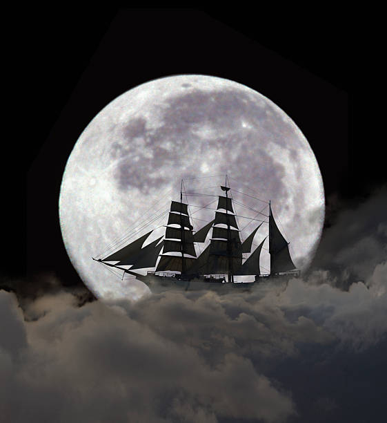 Conceptual image of sailboat on clouds in front of full moon at night