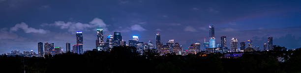 Austin, Texas skyline at night, showcasing the city's vibrant lights and modern architecture against a dark sky.