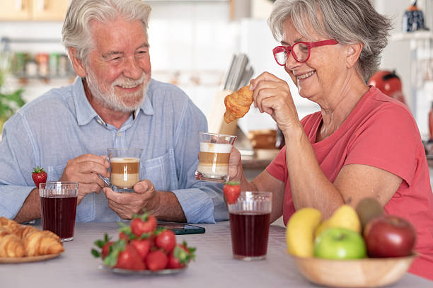 istock Attractive affectionate senior Caucasian couple smiling while having breakfast at home. Relaxed and happy seniors enjoying healthy nutrition 2227109020