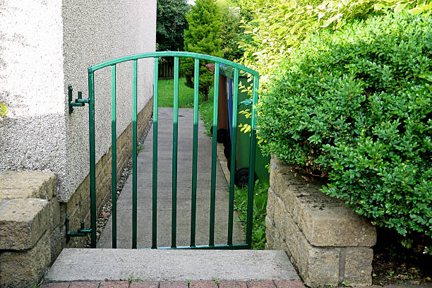 istock Small Gate Leading to an Urban House Garden Path 2227109589