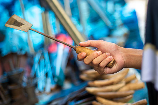 A man holds a sharp iron weapon in the market