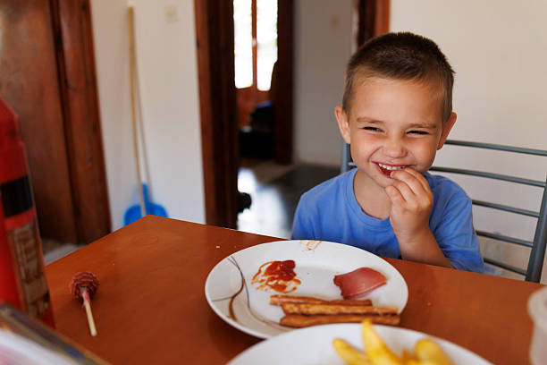 istock Cute little boy having breakfast at home 2227111610