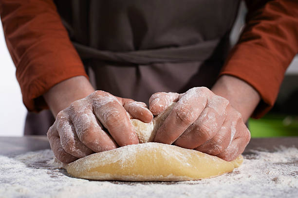 istock Baking concept. Caucasian female hands kneading the dough. 2227111684