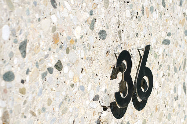 istock A wall with the number 36 on it that creates a shadow 2227113928