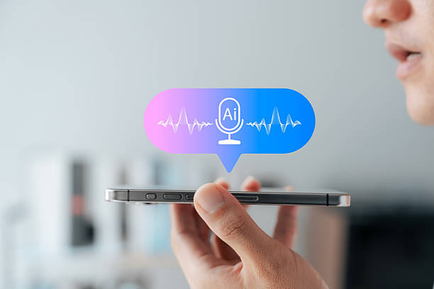 istock AI voice assistant technology concept. Close-up of man using speech recognition on smartphone with virtual microphone icon and soundwave. Future of mobile AI interface. 2227114287