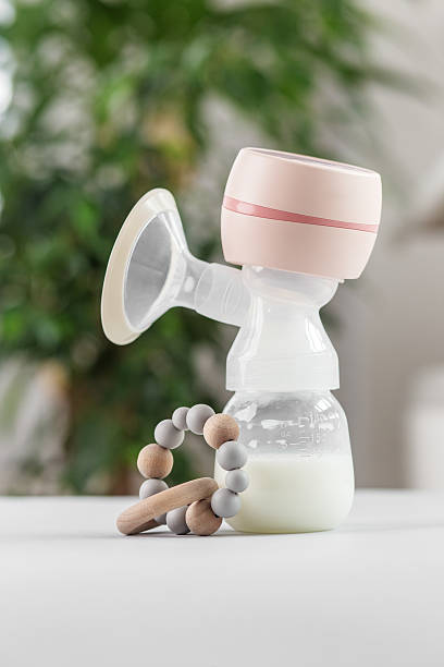 istock Electric breast pump with milk bottle and teether. Baby care. 2227115291