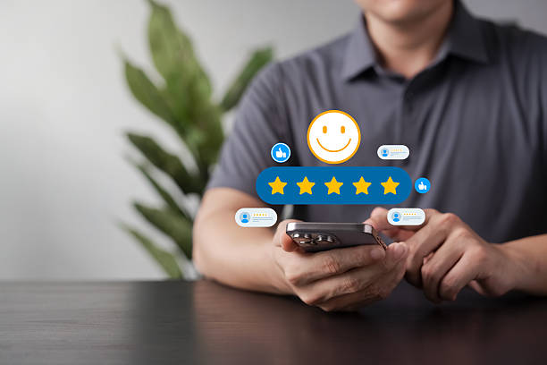 istock Customer feedback satisfaction,person using smartphone with five-star rating, smiley face icon, positive review comments, thumbs up, digital service evaluation, and online reputation management. 2227115914