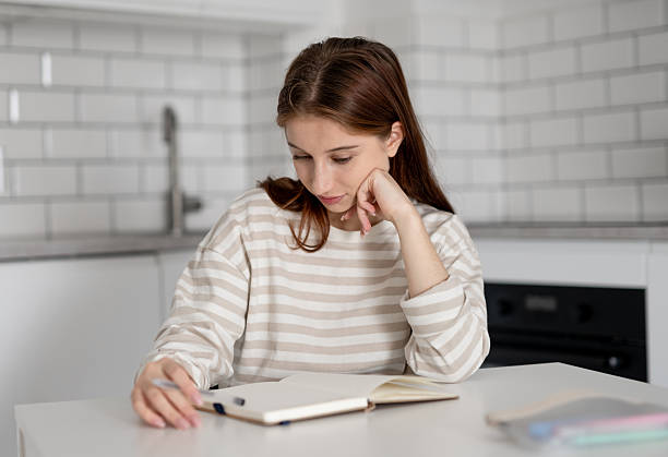 istock Happy Girl Doing Homework 2227118310