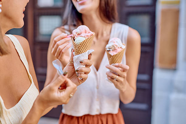 Two women enjoying ice cream cones on a summer day