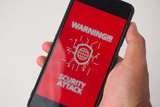istock Phone Screen Displaying Warning of Security Attack on Red Background 2227118932