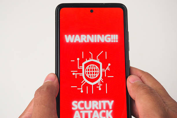 istock Phone Screen Displaying Warning of Security Attack on Red Background 2227119036