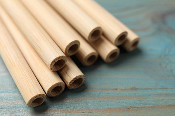 istock Bamboo drinking straws on light blue wooden table, closeup 2227119290
