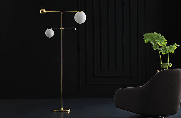 Modern gold floor lamp with frosted globe in dark interior