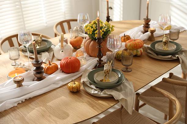istock Stylish table setting with beautiful dishware, glasses and autumn decor in dining room 2227120617