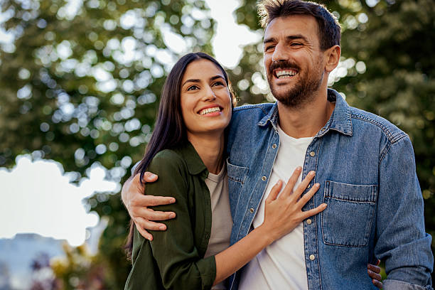 istock Romantic Walk: Couple Smiling and Bonding Outdoors 2227120754