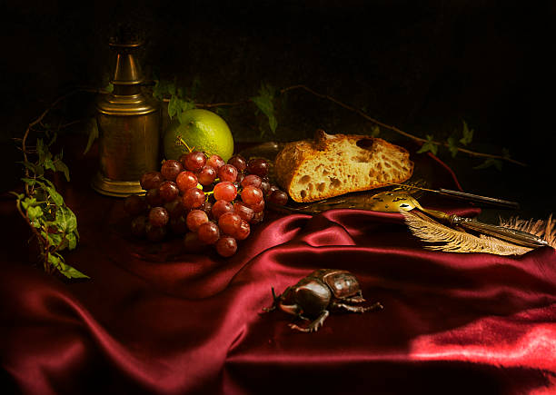 istock Baroque still life with red grapes, rustic bread and lemon on a maroon satin fabric 3 2227121145