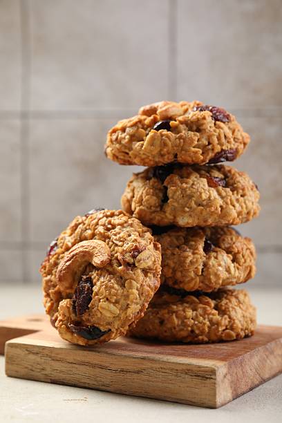 istock Delicious oatmeal cookies with raisins and nuts on light grey table 2227121162