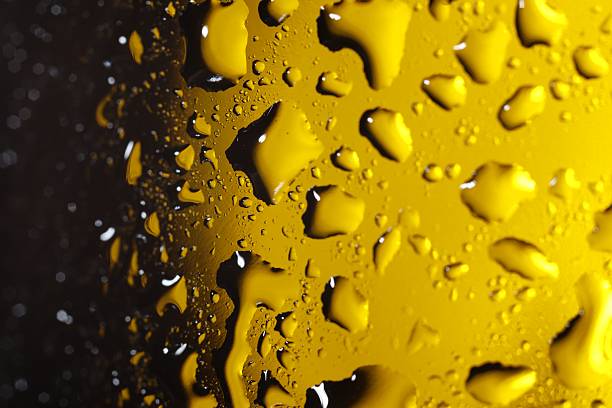 This image is taken with water droplets in a transparent plastic bottle surface, with evening light effect creating a beautiful and bubbly pattern.