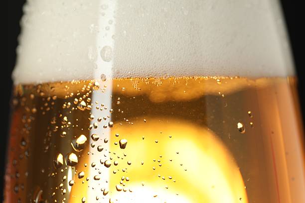 istock Glass of beer with condensation drops, macro view 2227121973