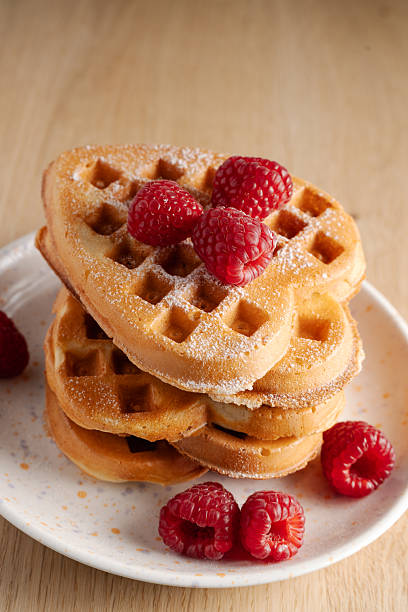 istock Stack of golden waffles with fresh raspberries 2227124398