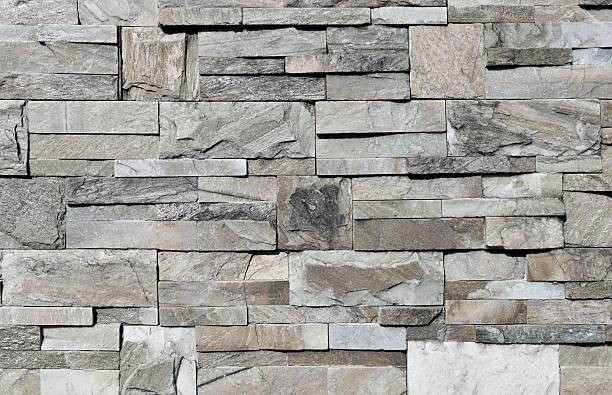 istock Grayish external wall made of stone bricks with different shapes and sizes. 2227126589
