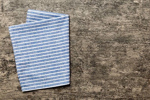 istock top view with blue kitchen napkin isolated on table background. Folded cloth for mockup with copy space, Flat lay. Minimal style 2227127260