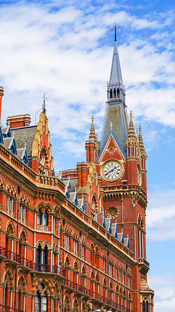 istock Victorian Gothic architecture with red bricks and clock tower in London city. 2227127697