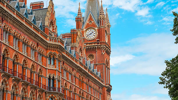 istock Victorian Gothic architecture with red bricks and clock tower in London city. 2227127750