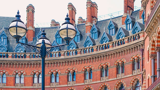 istock Victorian Gothic architecture with red bricks and clock tower in London city. 2227127872