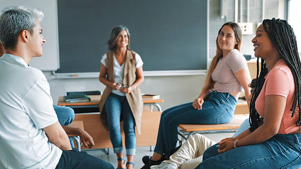 Multi-ethnic hispanic latin and African American students teacher a support debate conversation with teacher during a class in high school