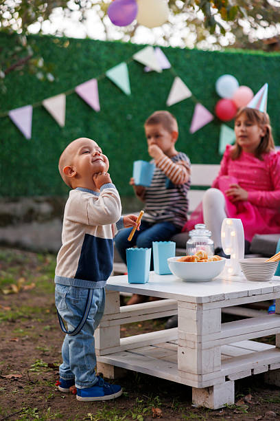 istock Children eating snacks while taking a beak from playing at birthday party 2227132682