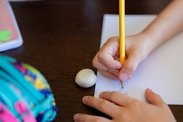 istock Child learning to write and doing homework at home 2227132987