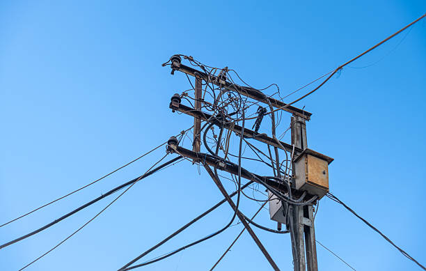 istock A tangle of wires on an old, rusty power pole. 2227134854