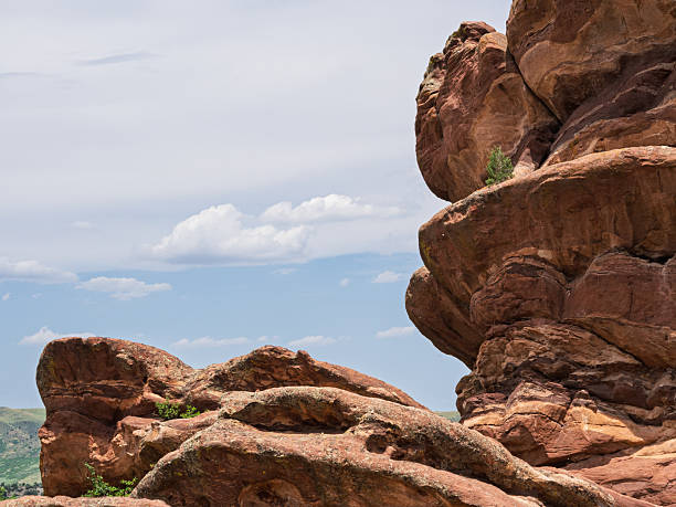 Striking red rock formations rise majestically against a dramatic cloudy sky in Colorado, USA.