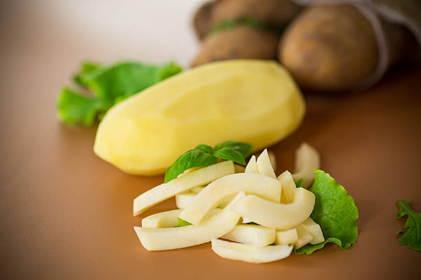 Detailed view of a person using a sharp knife to prepare healthy raw vegetables, emphasizing cooking skills and fresh ingredient handling for meal prep