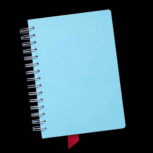 Light blue spiral notebook with red bookmark isolated on black background