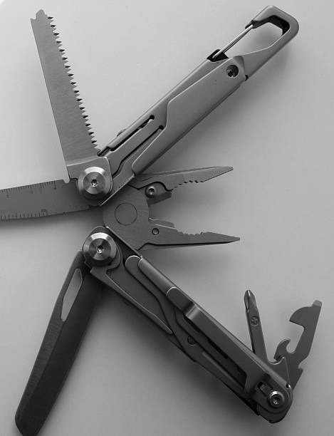 Opened Pliers on the Tip of Folding Multi Tool with Steel Handles Grayscale Image