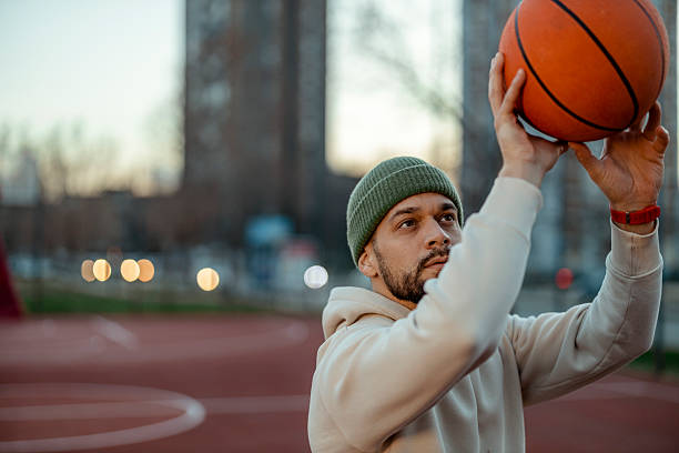 istock Young Basketball Player Practicing on Urban Court at Sunset 2227153340
