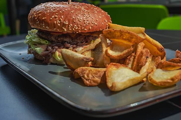 istock Juicy hamburger with crispy potato wedges. 2227155548